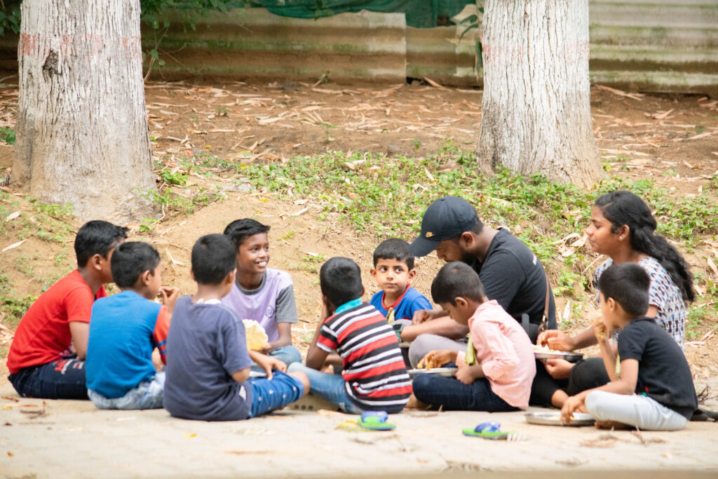 Children of Jeevarathni interacting with one of our volunteers