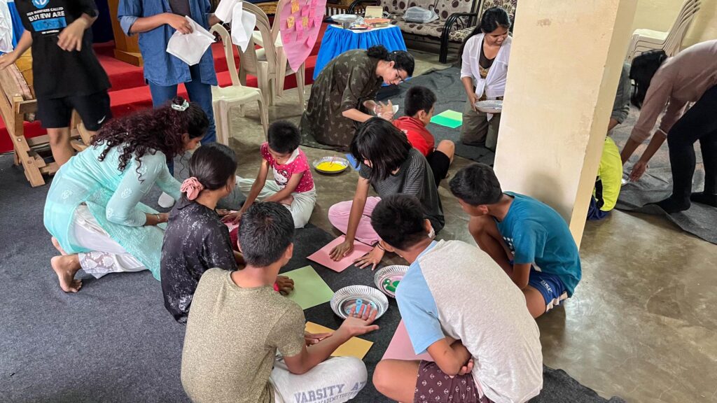 children engaging in fingerpainting